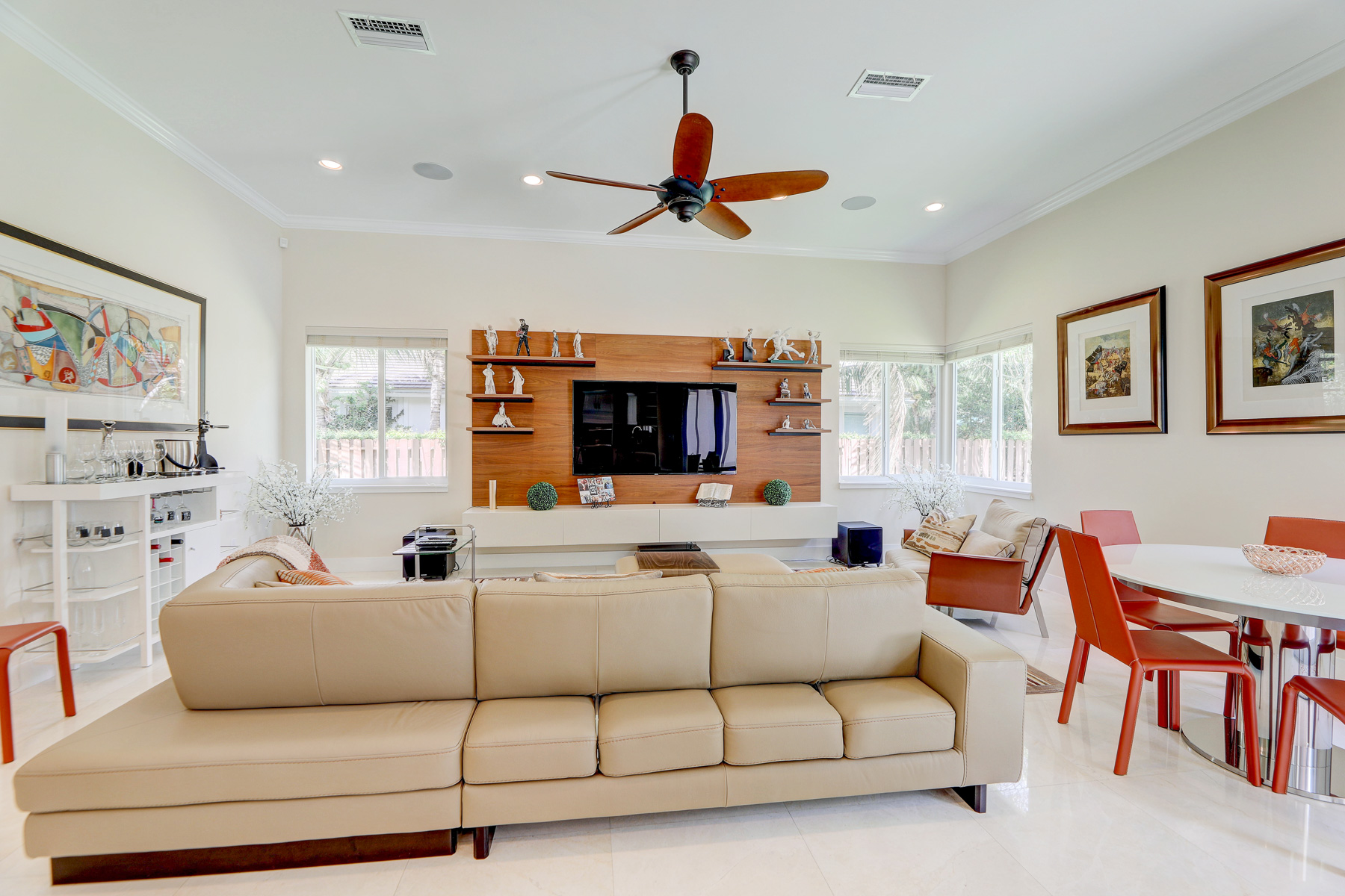 TV mounted on wall with beige couch